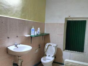 a bathroom with a toilet and a sink at Jungle House Kep in Kep