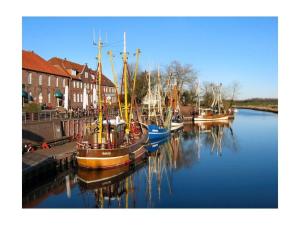 a group of boats are docked in a harbor at Cutter in the shiphouse in Hooksiel