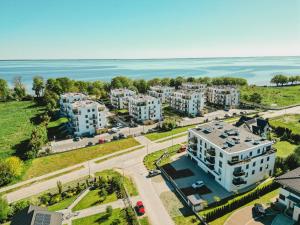 an aerial view of a building with the ocean in the background at Apart Harmony- Apartament Kaprów 6 in Puck