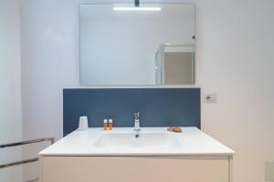 a bathroom with a white sink and a mirror at Dimore delle Zagare Molo in Syracuse