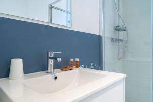 a bathroom with a white sink and a shower at Dimore delle Zagare Molo in Syracuse