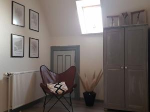 a living room with a chair and a window at FeWo Nero Comfortable holiday residence in Niebüll