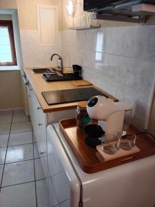 a kitchen with a counter with a mixer on a cutting board at Love Room Ange ou Démon à Aulnat in Aulnat