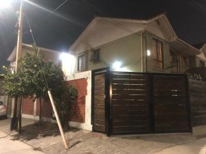 a house with a gate in front of it at night at Tu espacio Re - Cuarto con encanto in Santiago