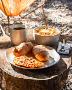 a plate of pastries and a cup of coffee on a table at Glampling Dos Quebradas in Floridablanca