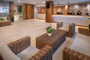vestíbulo con sillas de mimbre y sala de espera en GHT Oasis Tossa & Spa, en Tossa de Mar 37 fotos más
