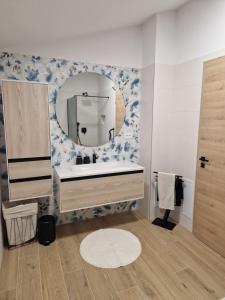 a bathroom with a sink and a mirror at Hiša Naj in Koper +19 photos