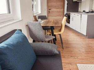 a living room with a couch and a table with chairs at Beautiful and Cosy Flat in Wagrain in Wagrain