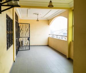an empty hallway with a door and a window at EG Studio-Carrefour ISTAMA-Sable Bonamoussadi-0m from Road in Douala