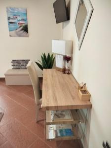 a dining room table with a lamp and a chair at Atena apartments in Agrigento