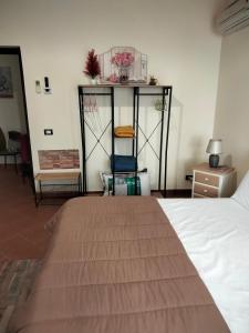 a bedroom with a bed and a table and a chair at Atena apartments in Agrigento