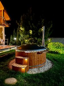 a hot tub sitting in the grass at night at Bikehouse in Veľká Lomnica