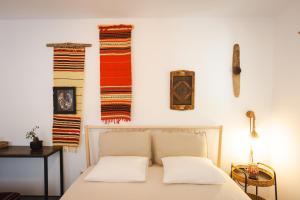 a bedroom with a bed with two pillows on it at Alunis Retreat in Aluniş