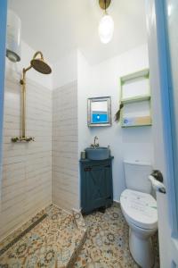 a bathroom with a toilet and a sink at Alunis RETREAT in Aluniş +99 photos