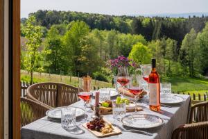 a table with wine glasses and a bottle of wine at steiRerBLiCke - Schilcherstöckl in Gamsgebirg