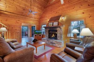 a living room with leather furniture and a fireplace at Peaceful Living Minutes from Blue Ridge hot tub pool table in Blue Ridge