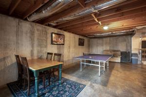 a ping pong table and chairs in a room at Peaceful Living Minutes from Blue Ridge hot tub pool table in Blue Ridge