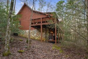 a log cabin in the woods with trees at Peaceful Living Minutes from Blue Ridge hot tub pool table in Blue Ridge