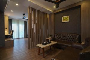 a living room with a couch and a table at Classic Regency in Alleppey