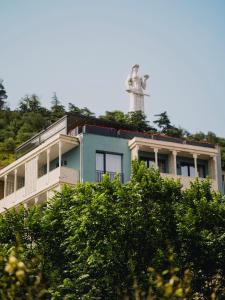 a building with a statue on top of it at Amante Narikala Boutique Hotel in Tbilisi City