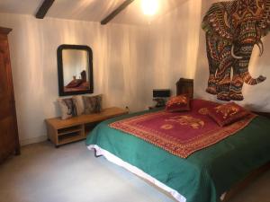 a bedroom with a bed and a mirror at Maison ancienne avec piscine au milieu des vignes 