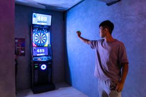 a man standing next to a video game machine at Cameron Lavender Mansion by PLAY in Brinchang +25 photos
