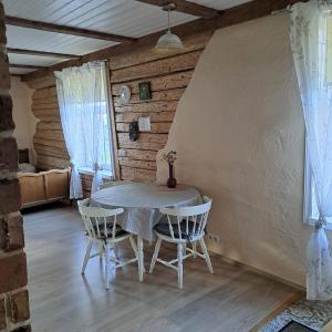 a dining room with a table and two chairs at Tagalahe Apartment in Haapsalu