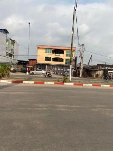 an empty street in front of a building at EG Studio-Carrefour ISTAMA-Sable Bonamoussadi-0m from Road in Douala