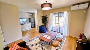 a living room with a table and a kitchen at goodRAC stay kyoto Kameoka in Yagi
