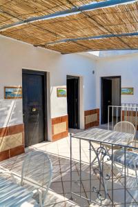 a patio with chairs and a table and a ceiling at B&B Baia Di Trentova in Agropoli