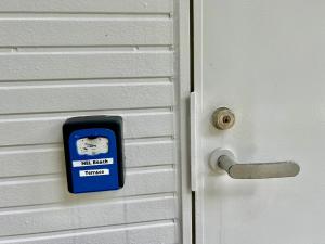 a door with a sign that reads risk agent refuge at Nel Beach in Nago