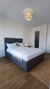 a bedroom with a large bed with white sheets at Résidence Montana Clamart in Clamart