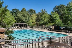 a large swimming pool with a fence around it at Chalet 254 - Cozy luxury in Big Canoe in Marblehill