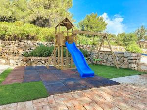 a playground with a blue slide in a yard at Salum in Trogir
