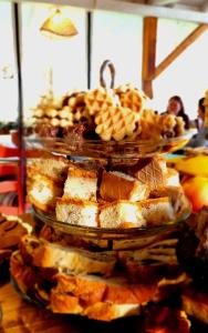 a stack of three plates of food on a table at Alunis Retreat in Aluniş
