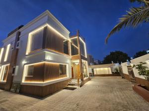a house with lights on the side of it at (Anushthan Villa) serviced villa for staycation in Ajman 