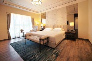 a hotel room with a bed and a window at Taj Bangalore in Devanahalli-Bangalore