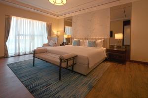 a bedroom with a large bed and a large window at Taj Bangalore in Devanahalli-Bangalore