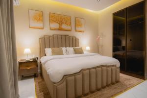 a bedroom with a large bed and two pictures on the wall at شقة بصالة وغرفة نوم ودخول ذاتي 8B in Riyadh