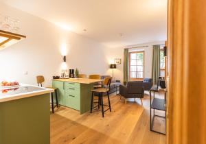 a kitchen and living room with a table and chairs at the salt vis à vis in Hallein