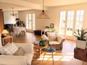 a living room with couches and a table at Maison de montagne in Saint Firmin +33 photos