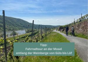 um par de pessoas a andar de bicicleta por uma estrada em Tropical Apartment em Koblenz