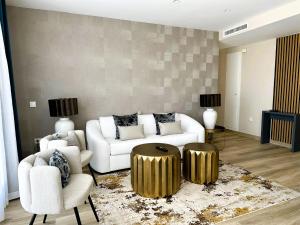 a living room with a white couch and gold accents at MD Pont de Fusta in Valencia