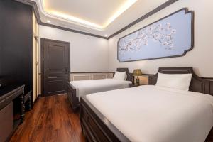 Postel nebo postele na pokoji v ubytování Sapa Soleil Hotel