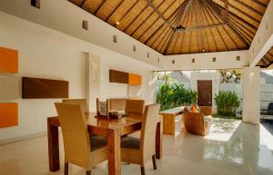 Bvilla Spa في سمينياك: غرفة طعام مع طاولة وكراسي خشبية