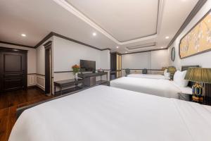 Postel nebo postele na pokoji v ubytování Sapa Soleil Hotel