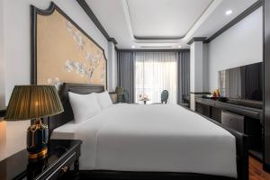 Postel nebo postele na pokoji v ubytování Sapa Soleil Hotel