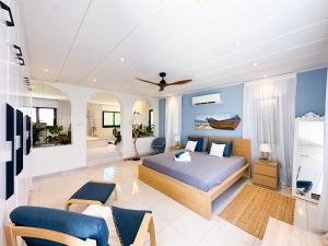 a bedroom with a bed and a living room at VILLA MYKONOS in Maa