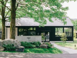 a black and white building with a tree at TEF TANIGUMI - Vacation STAY 78822v 