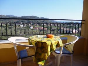 a table and chairs on a balcony with a view at Villa Helen in Arillas